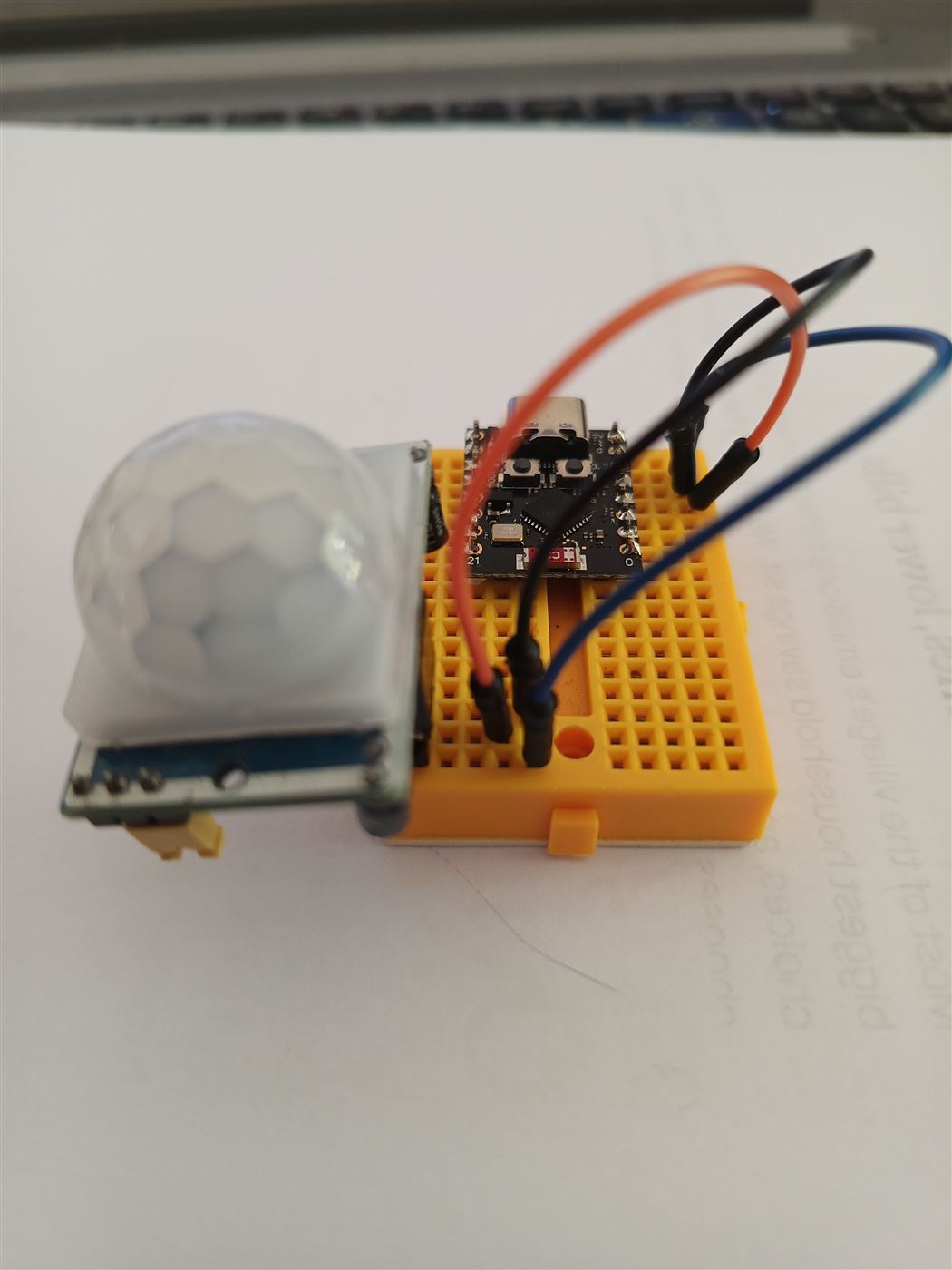 ESP32-C3 on a yellow mini breadboard wired to a PIR motion sensor
